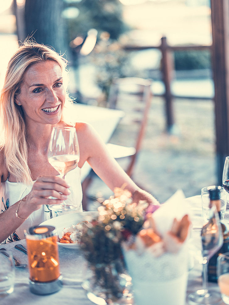Blonde woman drinking white wine
